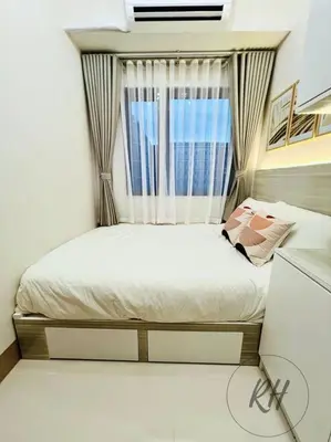 a small bedroom with a bed with a window at Minimalist and Serene 1BR Condo Unit near MOA in Manila