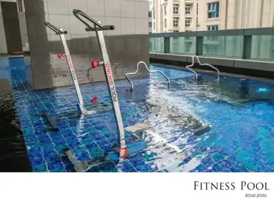 a swimming pool with two poles in the water at Urban Oasis Serenity in the City w Pool Gym More in Manila