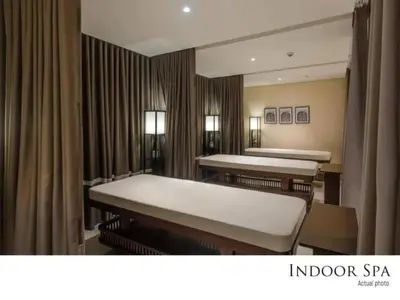 a treatment room with two beds and a mirror at Urban Oasis Serenity in the City w Pool Gym More in Manila