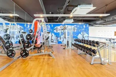 a gym with a bunch of treadmills and machines at Urban Oasis Serenity in the City w Pool Gym More in Manila