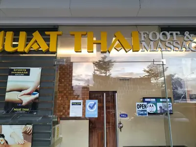 a store front with a sign that reads what thai massage at Comfy 19 shore2 Residence Free parking, Near Airport, IKEA, MOA, Pasay City in Manila