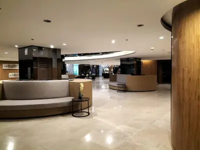 a lobby with couches and tables in a building at Comfy 19 shore2 Residence Free parking, Near Airport, IKEA, MOA, Pasay City in Manila
