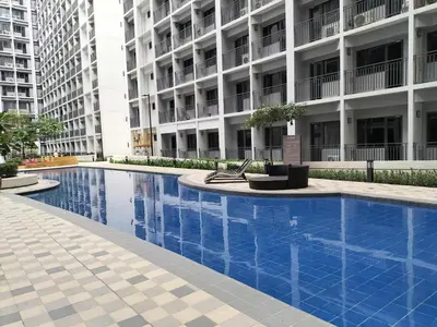 a swimming pool in front of a building at Comfy 22 shore2 Residence Free parking, Near Airport, IKEA, MOA, Pasay City in Manila