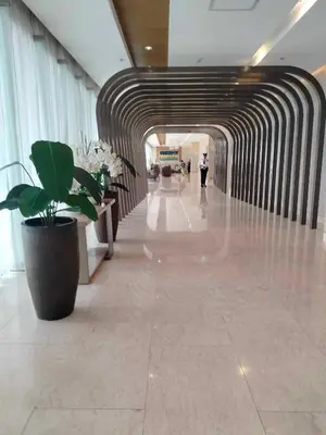a hallway in a building with a large potted plant at Comfy 42 shore 3 Residence Free parking, Near Airport, IKEA, MOA, Pasay City in Manila
