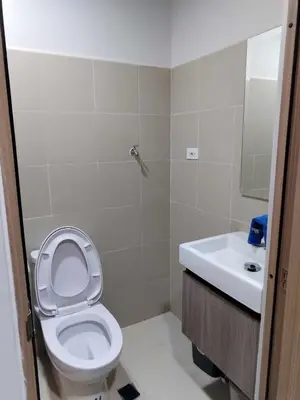a bathroom with a toilet and a sink at Comfy 42 shore 3 Residence Free parking, Near Airport, IKEA, MOA, Pasay City in Manila