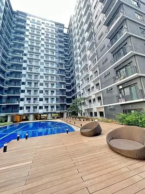 a courtyard with two benches and two tall buildings at Comfy 42 shore 3 Residence Free parking, Near Airport, IKEA, MOA, Pasay City in Manila