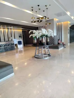 a lobby with vases of flowers on a table at Comfy 42 shore 3 Residence Free parking, Near Airport, IKEA, MOA, Pasay City in Manila