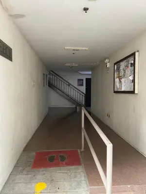 an empty hallway with a staircase and a red carpet at Hungary109 Service Apartments Near Airport at Kassel Residences in Manila