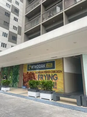 a building with a sign on the side of it at Shore Residences Tower D - One Bedroom I Good for 6 guests I Walk to Mall of Asia in Manila