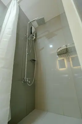 a bathroom with a shower with a shower at Modern Living 1 Makati in Manila