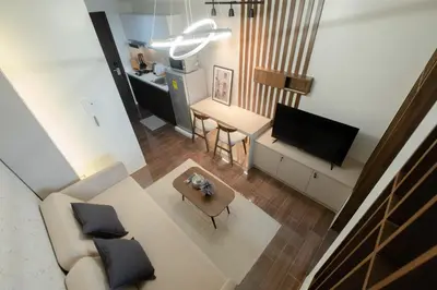 an overhead view of a living room with a couch and a television at Modern Living 1 Makati in Manila