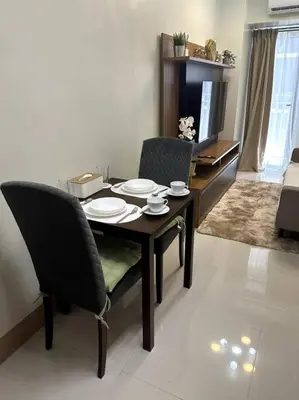 a dining room table and chairs in a living room at Ellie's Place Shore 3 T3 in Manila