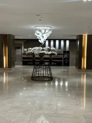 a lobby with a flower display in the middle of a building at Ellie's Place Shore 3 T3 in Manila