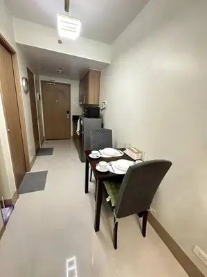 a kitchen with a table and chairs in a room at Ellie's Place Shore 3 T3 in Manila