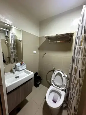a bathroom with a white toilet and a sink at Ellie's Place Shore 3 T3 in Manila