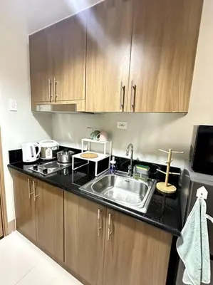 a kitchen with a sink and a microwave at Ellie's Place Shore 3 T3 in Manila