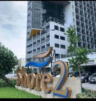 a sign in front of a building with a slide at Shore2 Condo 1BR Balcony, Wifi, Pool, MOA, Airport in Manila