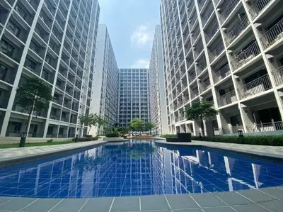 a swimming pool in a city with tall buildings at Shore2 Condo 1BR Balcony, Wifi, Pool, MOA, Airport in Manila