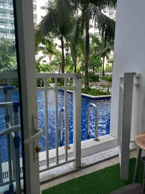 a view of the pool from the balcony of a resort at Shore Residence Direct Pool Access MOA Complex in Manila