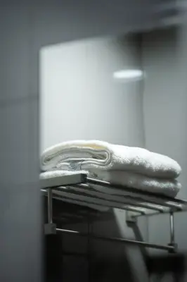 a pile of towels sitting on top of a rack at Modern Living 3 Makati in Manila