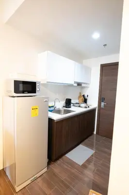 a kitchen with a refrigerator and a sink at Modern Living 3 Makati in Manila