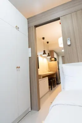 a bedroom with a bed and a dining room at Modern Living 4 MOA Pasay in Manila