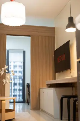 a living room with a television on a wall at Modern Living 4 MOA Pasay in Manila