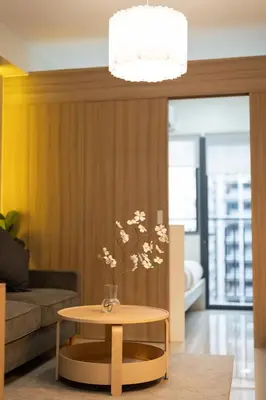 a living room with a table and a couch at Modern Living 4 MOA Pasay in Manila