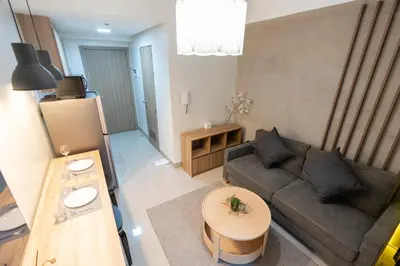 a living room with a couch and a table at Modern Living 4 MOA Pasay in Manila