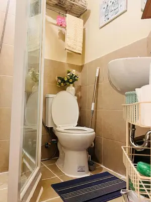 a bathroom with a toilet and a sink at Cozy apartment near Greenbelt Makati City in Manila