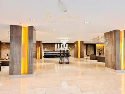 a lobby of a hotel with yellow and gray pillars at The Luxe Haven Shore 3 Residences in Manila
