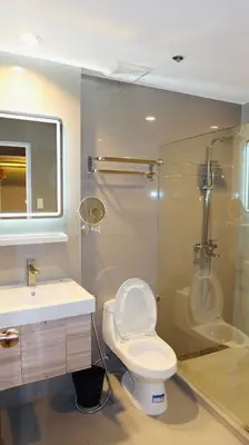 a bathroom with a toilet and a shower and a sink at Centennial Inn in Kawit