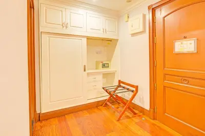 a room with a kitchen with white cabinets and a door at Townhouse OAK Makati Manila Near PNR Pasay Evangelista formerly VIP Suites in Manila