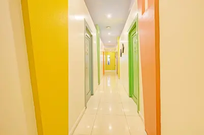 a hallway with yellow and green doors at Townhouse OAK Makati Manila Near PNR Pasay Evangelista formerly VIP Suites in Manila