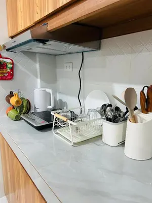 a kitchen counter with a dish drying rack on it at Tagaytay's Cozy Loft-type Forest House and Camp in Silang