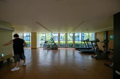 a man in a gym with several treadmills at Ocuna Suite - NAIA Manila Airport in Manila