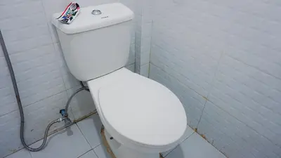 a bathroom with a white toilet in a stall at Tinyhaven Transient Cabuyao in Cabuyao