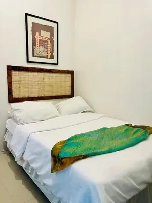a white bed with a colorful blanket on it at Spacious 1BR steps to Megamall Ortigas City View in Manila