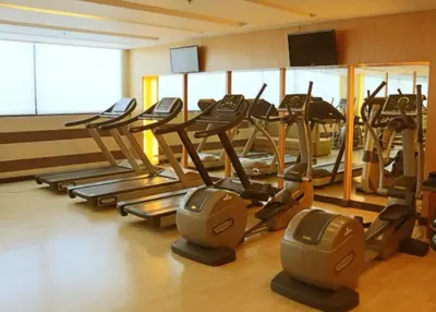 a gym with a bunch of treadles in a room at Spacious 1BR steps to Megamall Ortigas City View in Manila