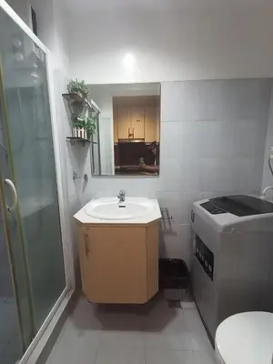 a small bathroom with a sink and a shower at Sea Residences Staycation Near Moa Pasay by Jhay in Manila