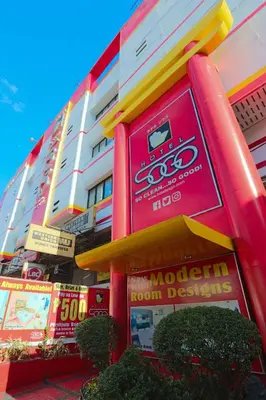 a building with colorful signs in front of it at Hotel Sogo - Pasay Rotonda in Manila
