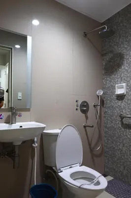 a bathroom with a toilet and a sink at Hotel Sogo - Pasay Rotonda in Manila