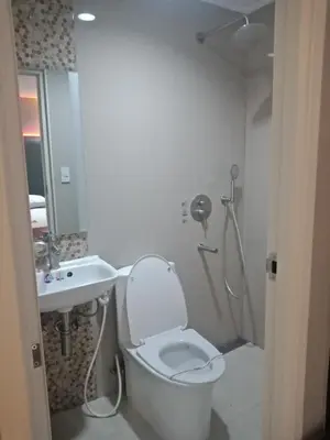 a bathroom with a toilet and a sink and a shower at Hotel Sogo - Pasay Rotonda in Manila