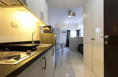 a kitchen with a sink and a counter top at Condo Studio Luxe in Princeton Residences in Manila