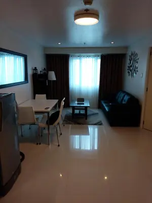 a living room with a table and a couch at Condo Studio Luxe in Princeton Residences in Manila