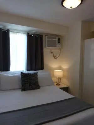 a bedroom with a large bed with a window at Condo Studio Luxe in Princeton Residences in Manila