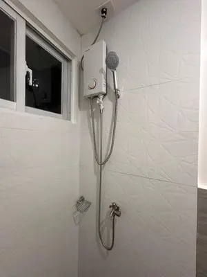 a shower with a blow dryer in a bathroom at Origin Studios - Walk to Highstreet, BGC in Manila
