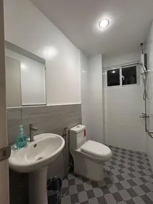a bathroom with a white toilet and a sink at Origin Studios - Walk to Highstreet, BGC in Manila