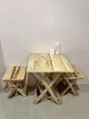 a wooden table with two benches next to a wall at Origin Studios - Walk to Highstreet, BGC in Manila