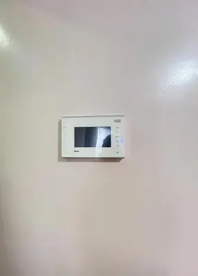 a microwave hanging on a white wall at Cozy Condo at Eighty One Newport Blvd across NAIA Terminal 3 in Manila